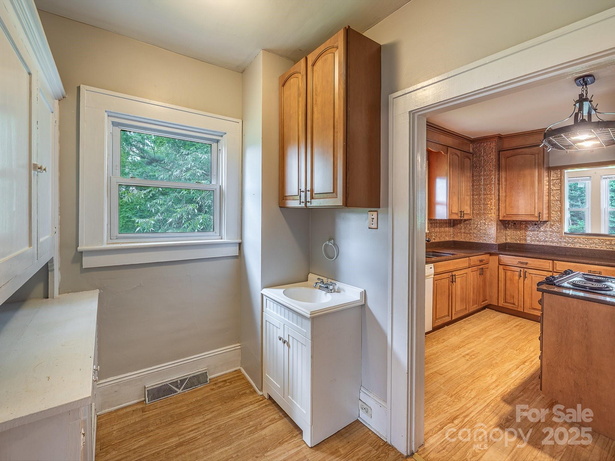 808 West Union Street Morganton, NC 28655 - Photo 20 of 40 a kitchen with granite countertop wooden cabinets and a counter top space