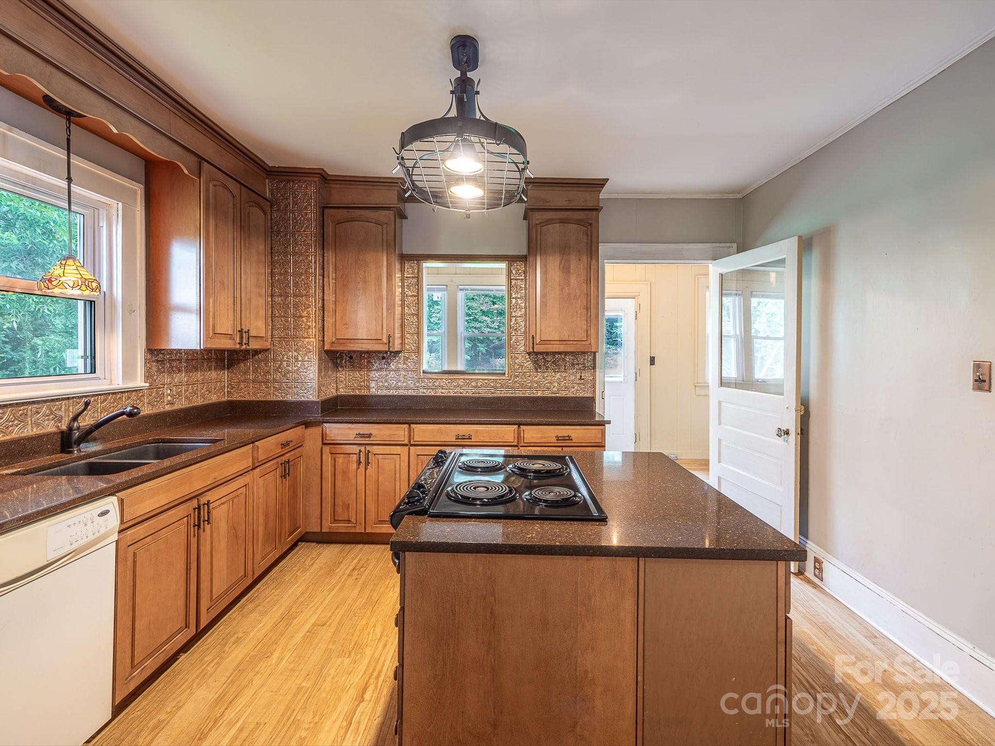 808 West Union Street Morganton, NC 28655 - Photo 21 of 40 a kitchen with granite countertop stainless steel appliances a sink stove and cabinets