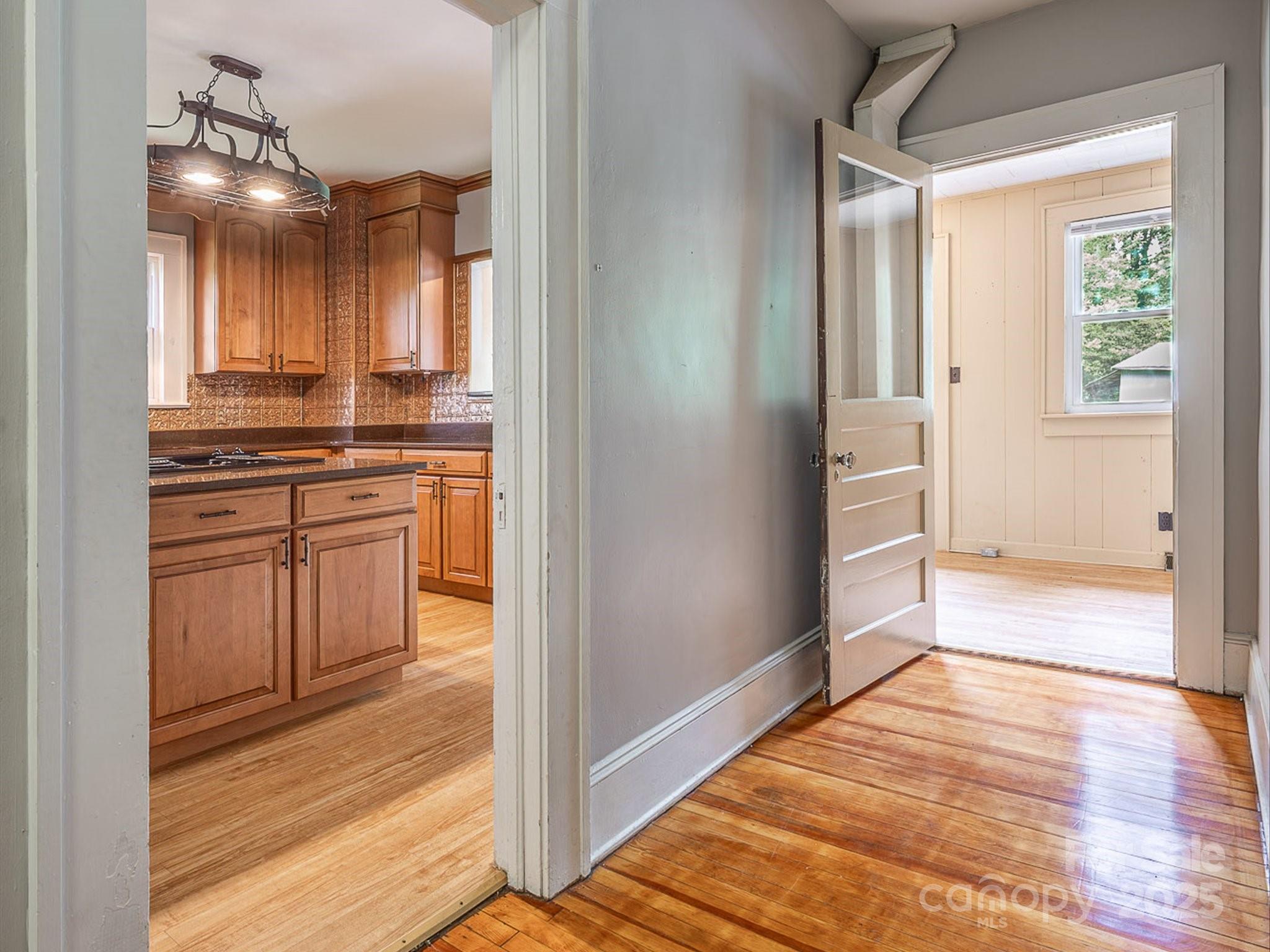 808 West Union Street Morganton, NC 28655 - Photo 24 of 40 a view of a kitchen from the hallway with closet and wooden floor