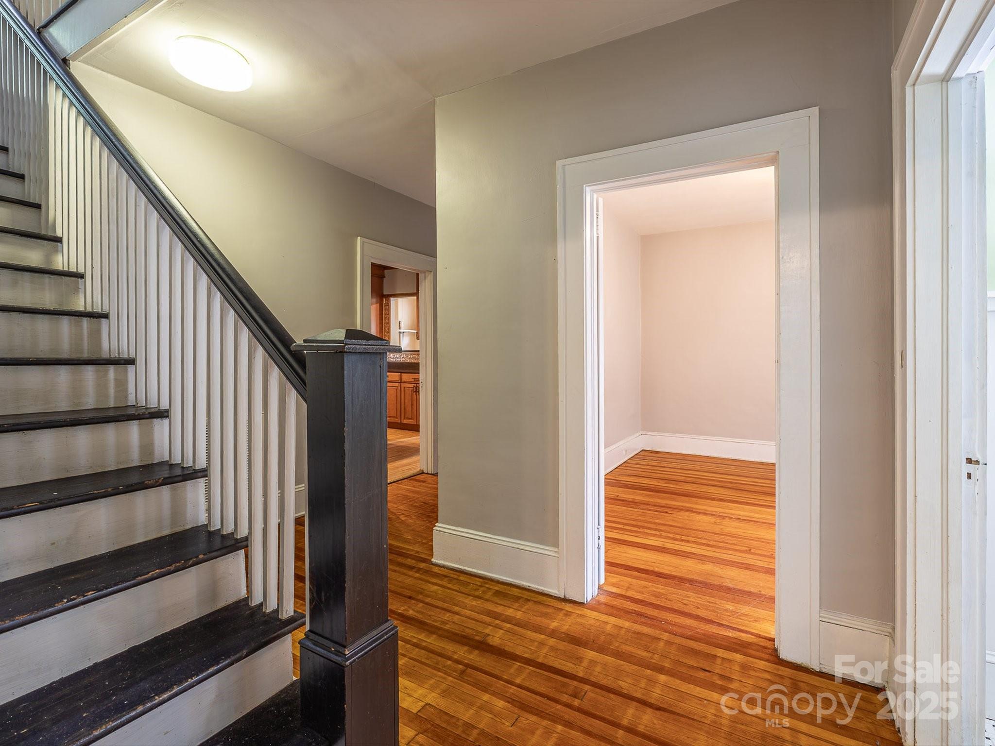 808 West Union Street Morganton, NC 28655 - Photo 25 of 40 a view of a hallway with wooden floor and staircase