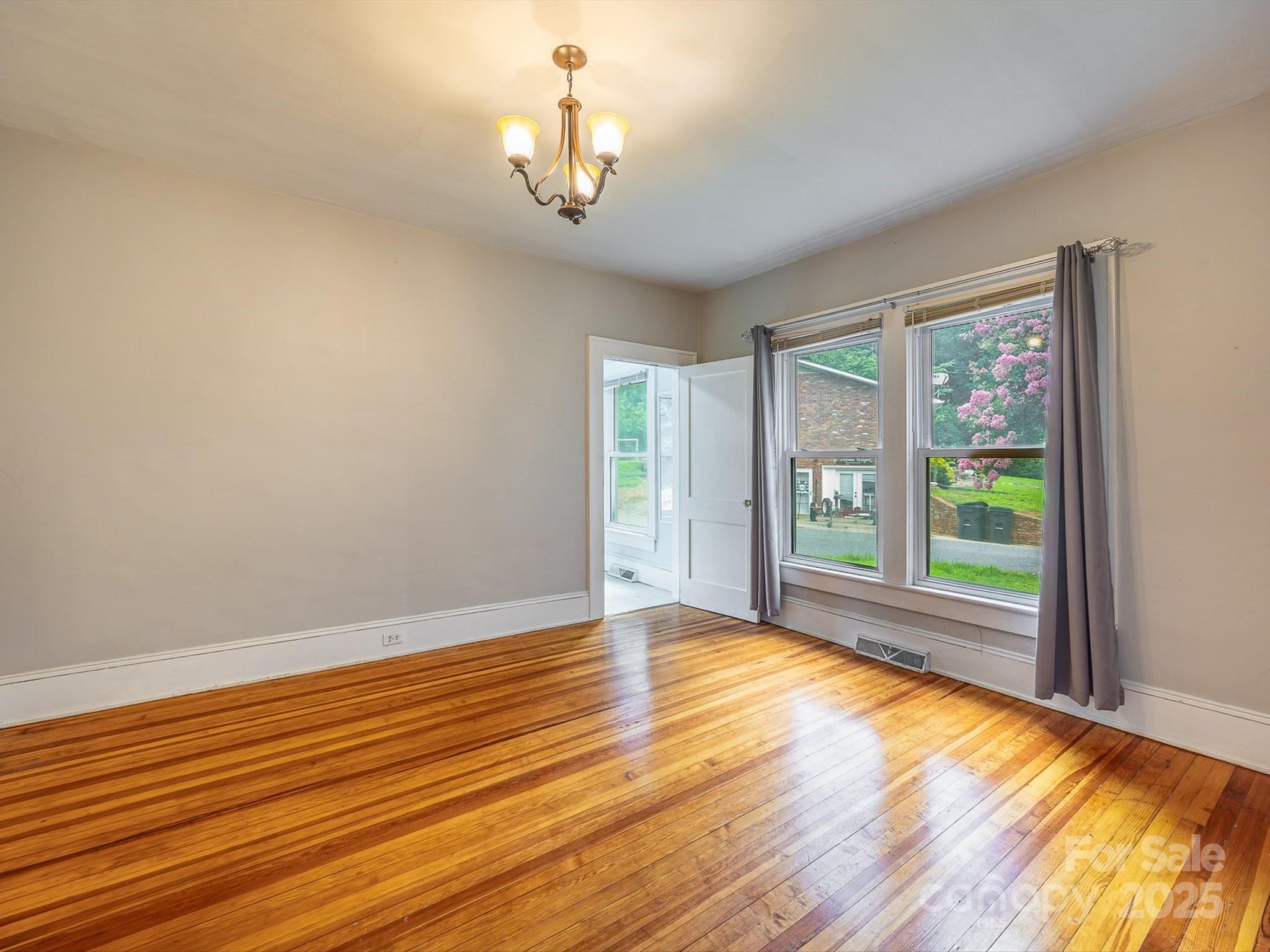 808 West Union Street Morganton, NC 28655 - Photo 28 of 40 a view of empty room with wooden floor and fan