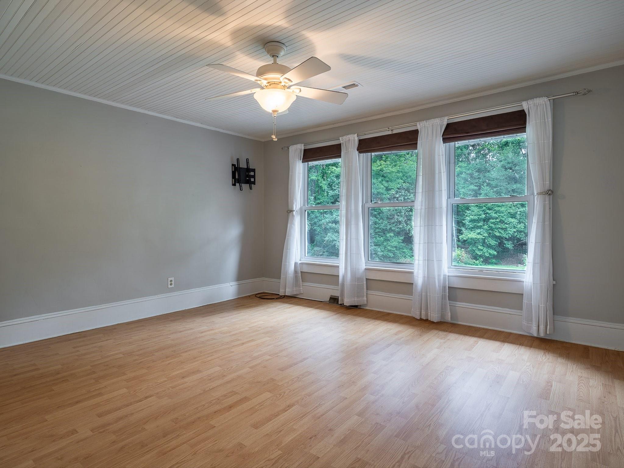 808 West Union Street Morganton, NC 28655 - Photo 33 of 40 a view of an empty room with wooden floor and a window