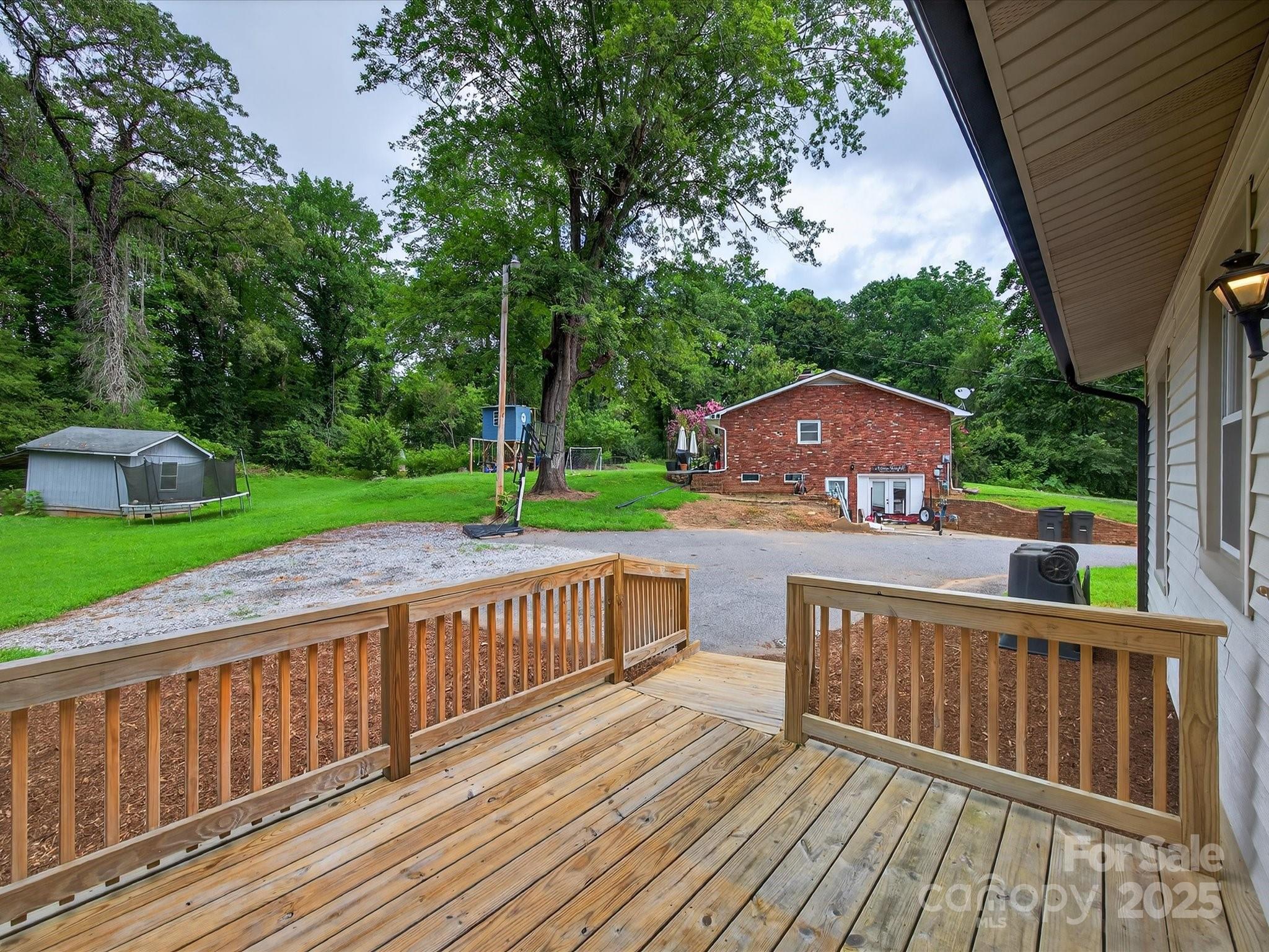 808 West Union Street Morganton, NC 28655 - Photo 40 of 40 a view of a deck with wooden floor and fence next to a yard