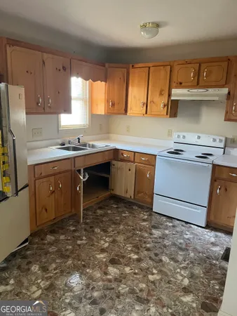 a kitchen with a sink stove and cabinets