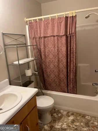 a bathroom with a toilet and shower