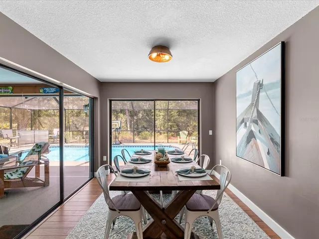 a kitchen with stainless steel appliances granite countertop a kitchen island a stove a table and chairs in it