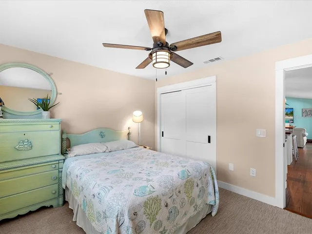 a bedroom with a bed and a ceiling fan