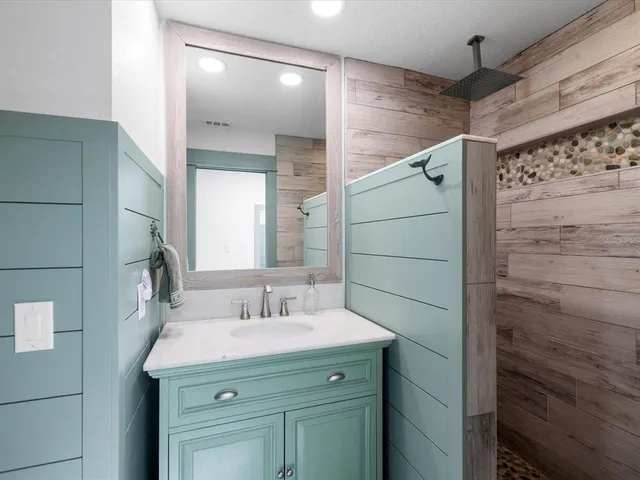 a bedroom with a bed and wooden table