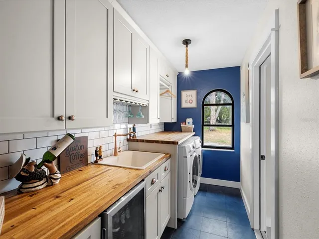 a bedroom with bed and a chandelier
