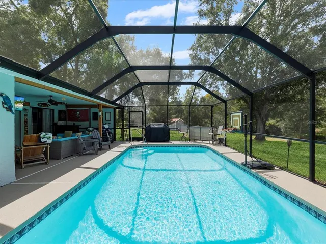 an aerial view of a house a yard and a swimming pool