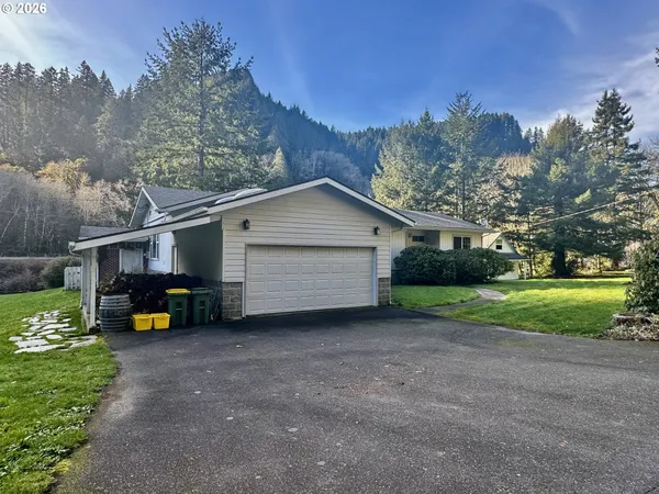a view of a house with a backyard and tree