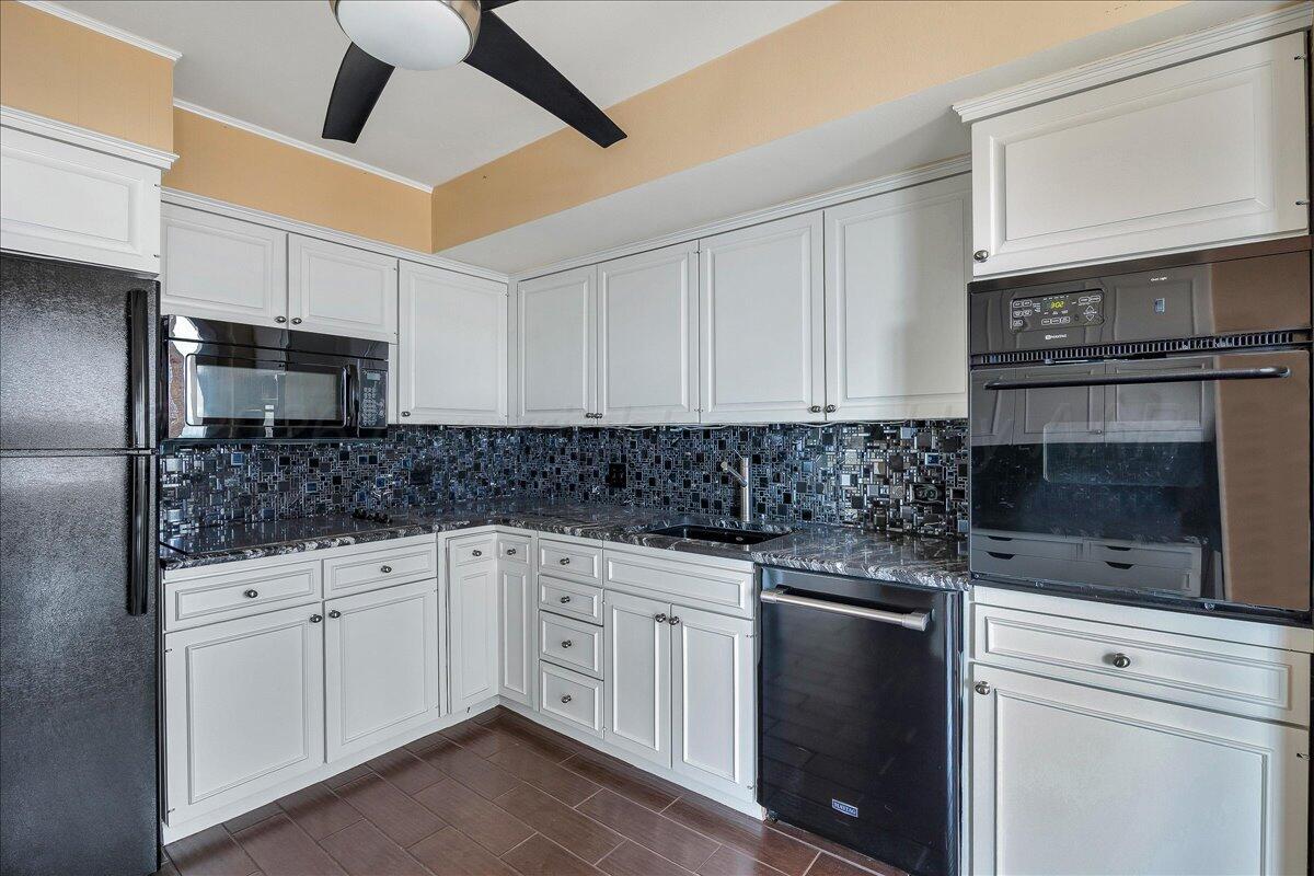 2028 South Austin Street, Unit 907 Amarillo, TX 79109 - Photo 13 of 39 a kitchen with white cabinets stainless steel appliances and sink