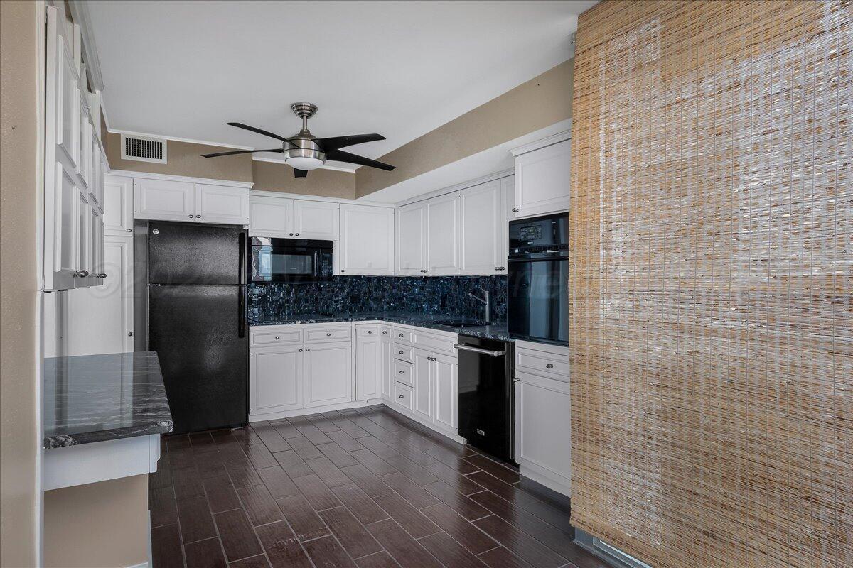 2028 South Austin Street, Unit 907 Amarillo, TX 79109 - Photo 14 of 39 a kitchen with stainless steel appliances a refrigerator a sink and white cabinets