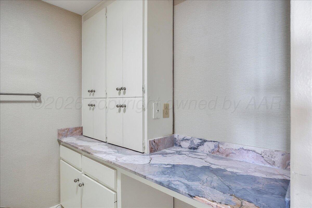 2028 South Austin Street, Unit 907 Amarillo, TX 79109 - Photo 19 of 39 a bathroom with a granite countertop sink and a mirror