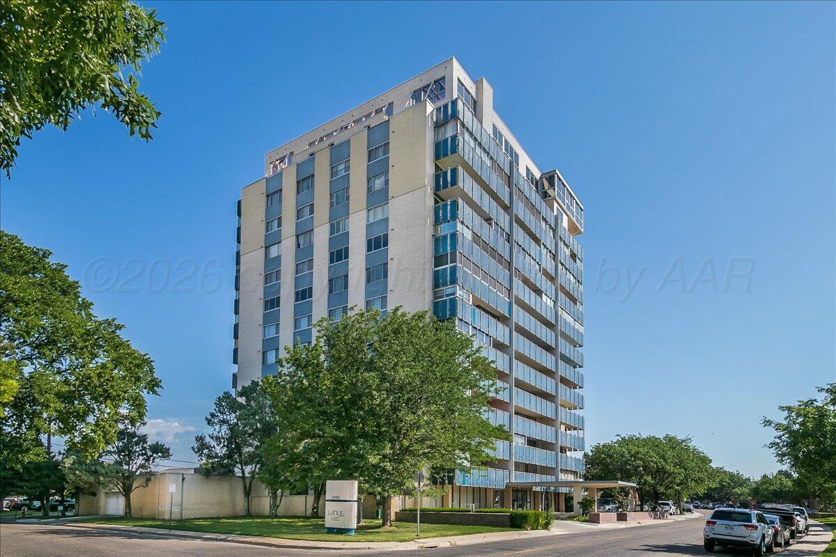 2028 South Austin Street, Unit 907 Amarillo, TX 79109 - Photo 2 of 39 a view of a tall building next to a road