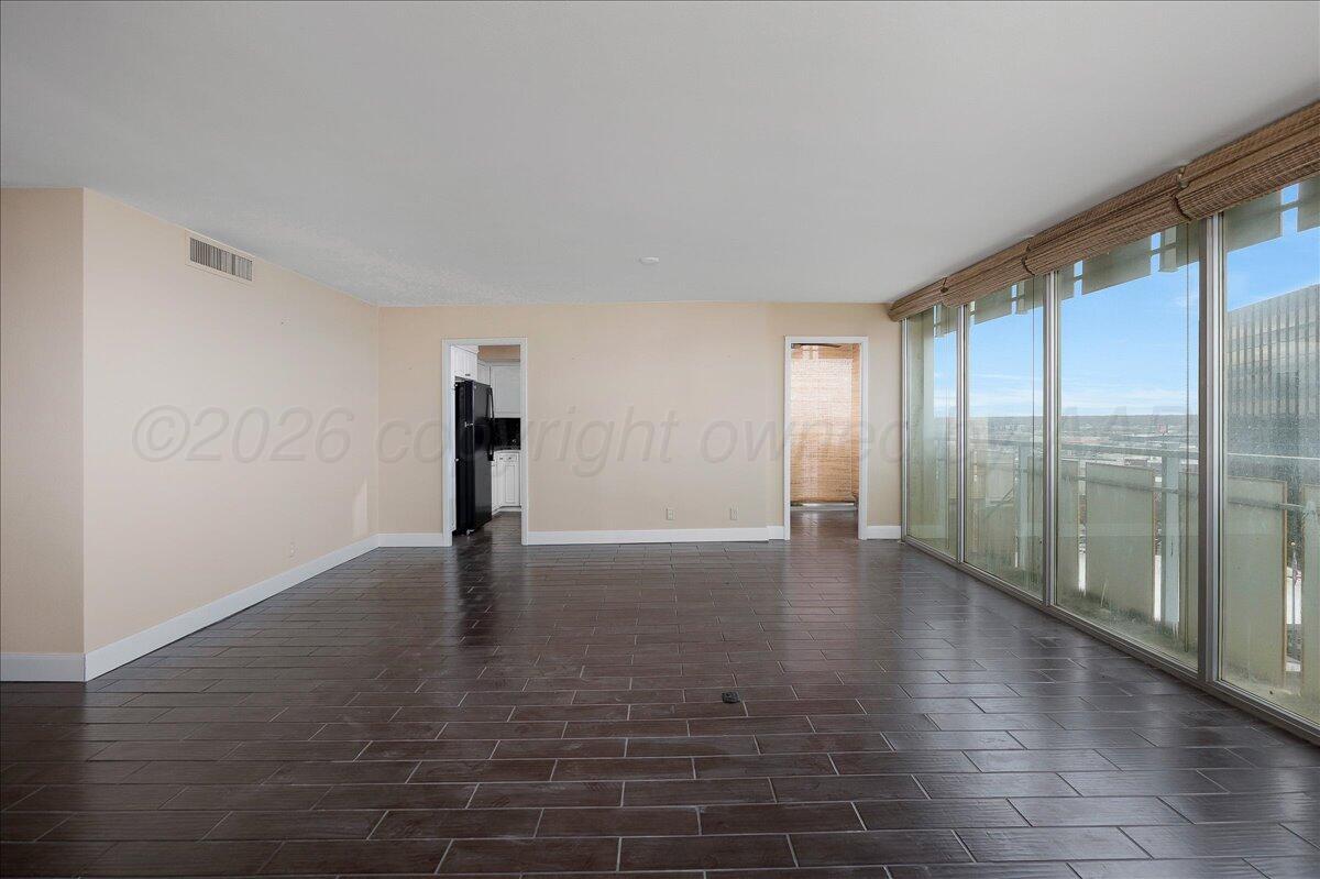 2028 South Austin Street, Unit 907 Amarillo, TX 79109 - Photo 5 of 39 a view of empty room with floor to ceiling window