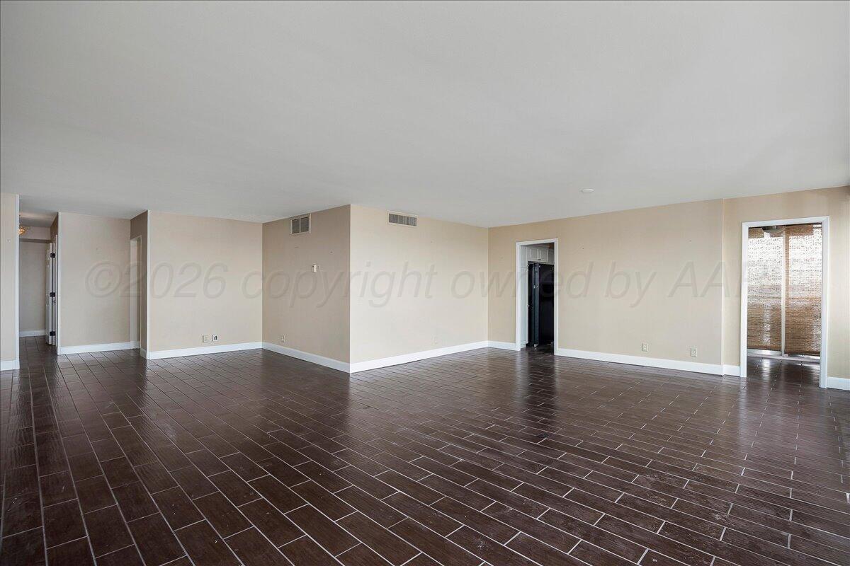 2028 South Austin Street, Unit 907 Amarillo, TX 79109 - Photo 6 of 39 a view of empty room with wooden floor