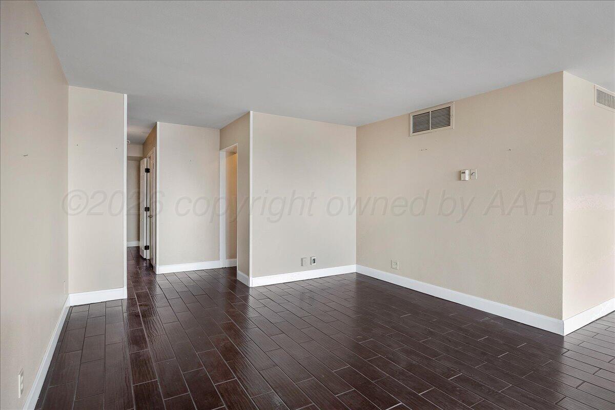 2028 South Austin Street, Unit 907 Amarillo, TX 79109 - Photo 8 of 39 a view of an empty room with wooden floor