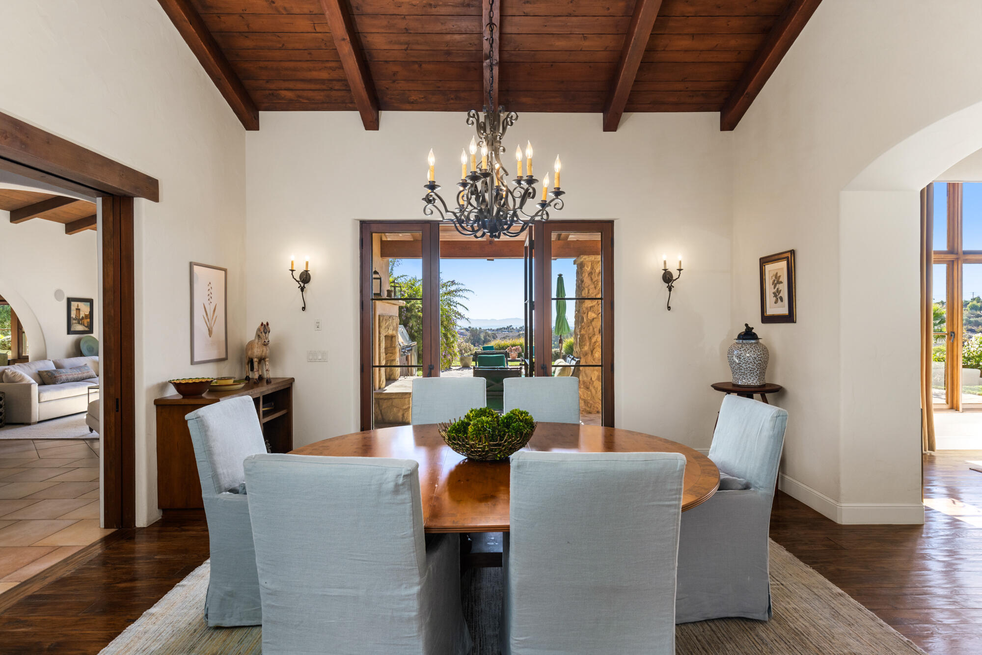 1220 Franklin Ranch Road Goleta, CA 93117 - Photo 7 of 30 a dining room with furniture a chandelier and wooden floor