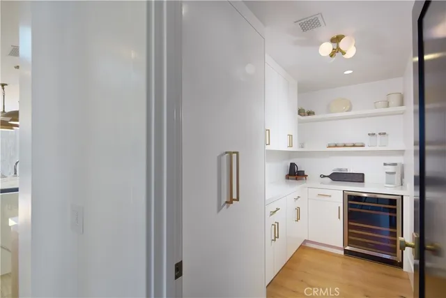 a kitchen with a refrigerator a stove and cabinets