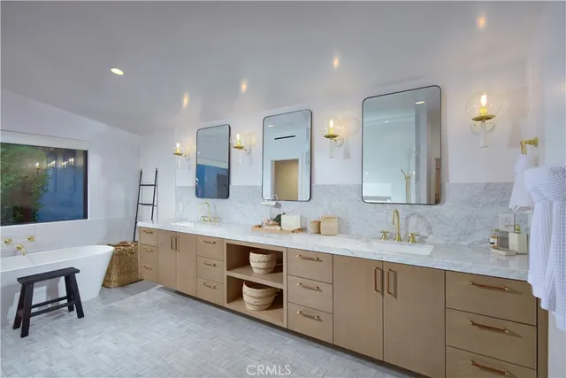 a spacious bathroom with a double vanity sink and a mirror