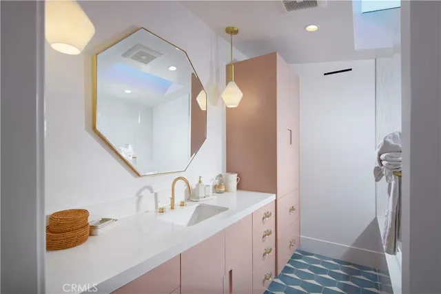 a bedroom with two beds and painting on the wall