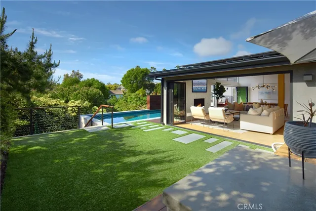 a view of backyard with seating space and trees