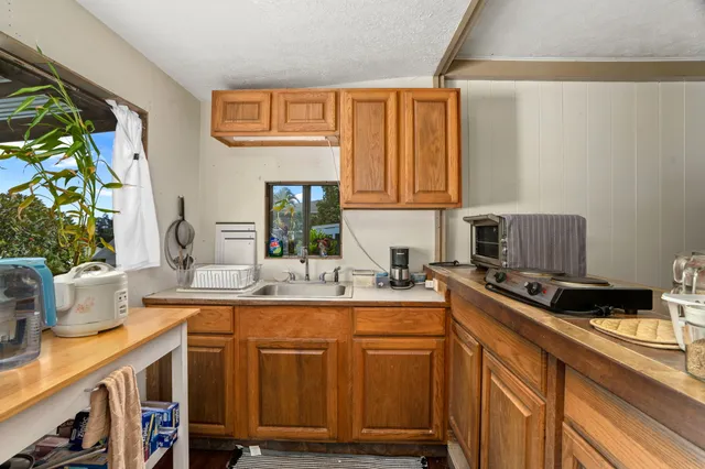 a kitchen with stainless steel appliances granite countertop a sink and a cabinets