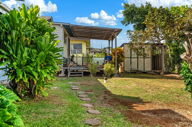 a view of a house with backyard and sitting area