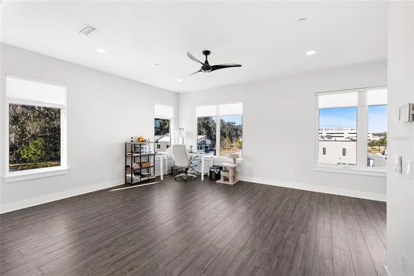 a view of a livingroom with hardwood floor and a ceiling fan