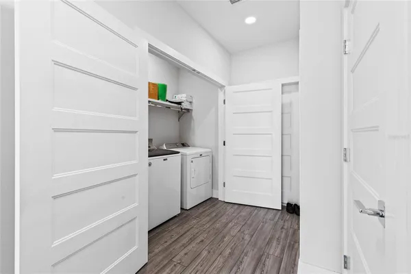 a view of a bedroom with wooden floor