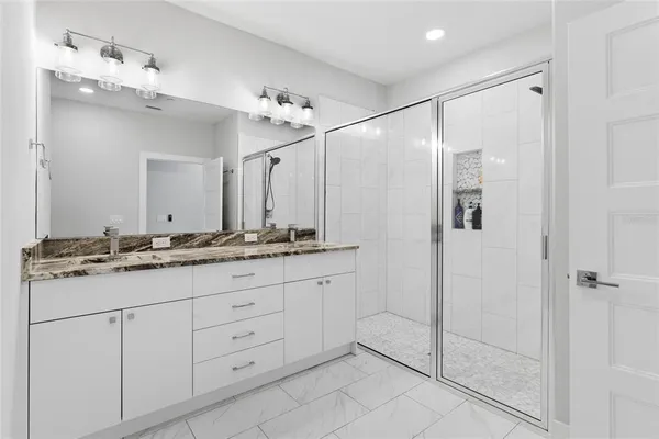 a bathroom with a granite countertop sink mirror and double