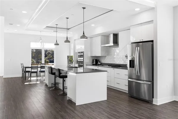 a kitchen with refrigerator cabinets and wooden floor