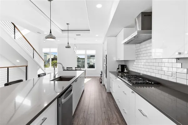 a kitchen with stainless steel appliances kitchen island granite countertop a stove a sink a refrigerator and window