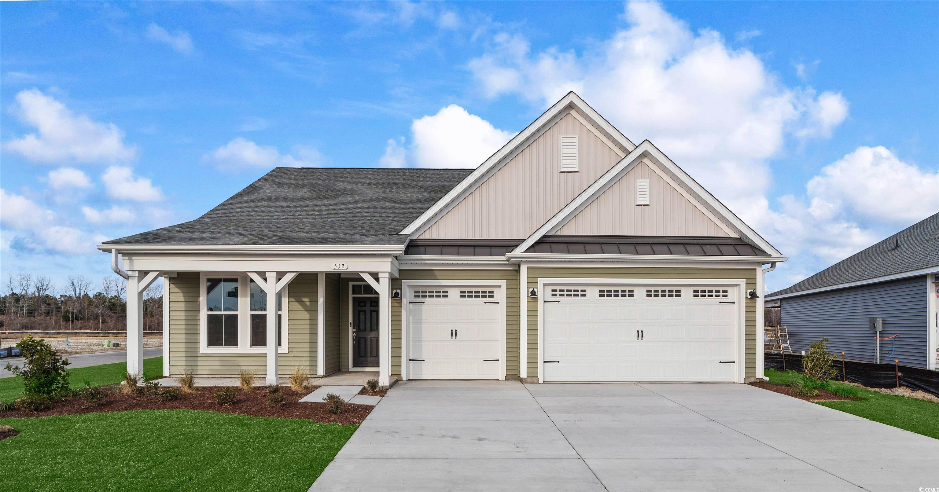 View of front facade with board and batten siding, driveway, roof with shingles, and an attached garage