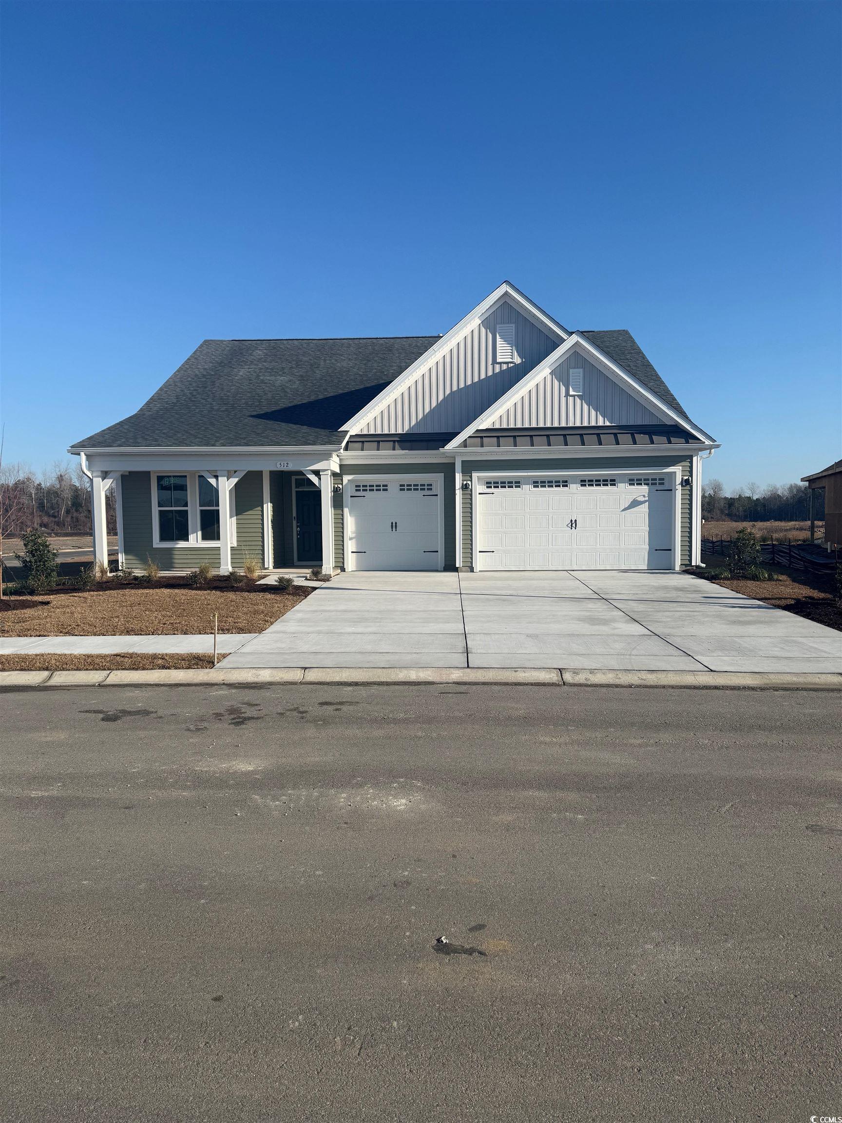 512 Banna Arch Loop Myrtle Beach, SC 29579 - Photo 1 of 12 View of front facade with board and batten siding, driveway, roof with shingles, and an attached garage