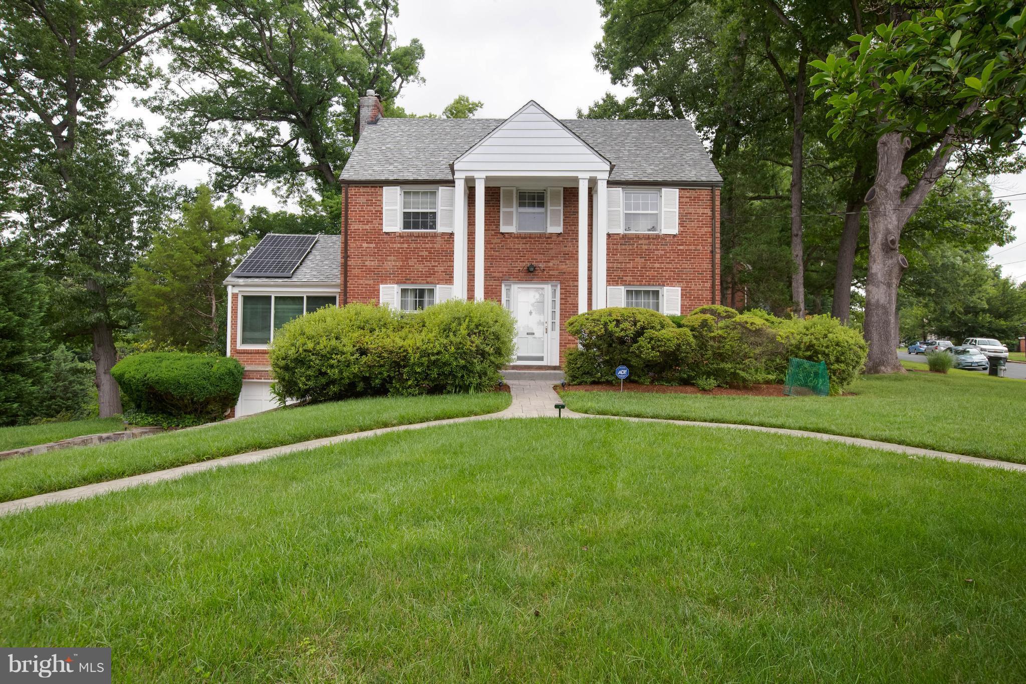 9600 Sutherland Road Silver Spring, MD 20901 - Photo 1 of 30 a front view of a house with a yard