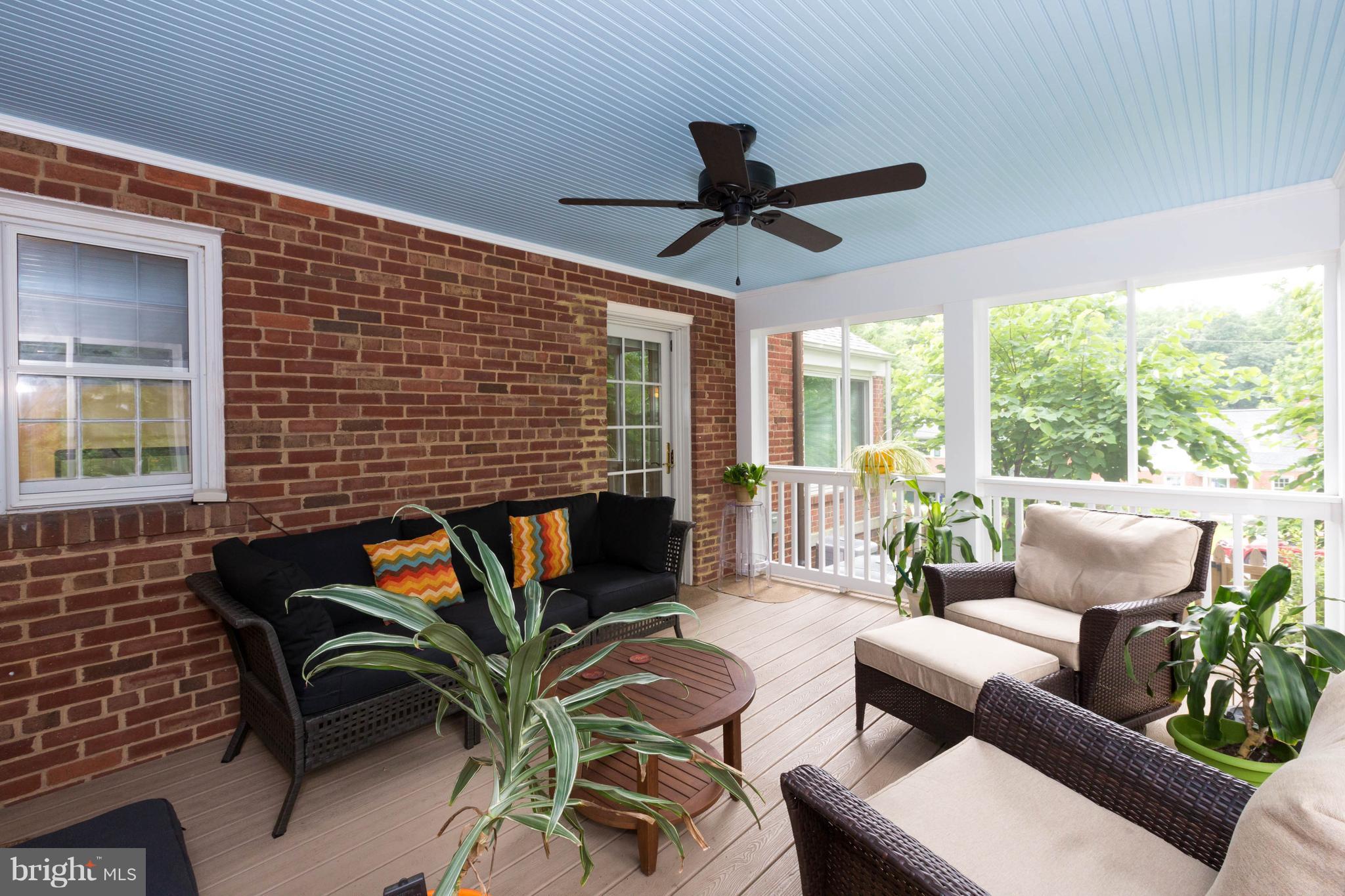 9600 Sutherland Road Silver Spring, MD 20901 - Photo 12 of 30 a living room with furniture floor to ceiling window and a potted plant