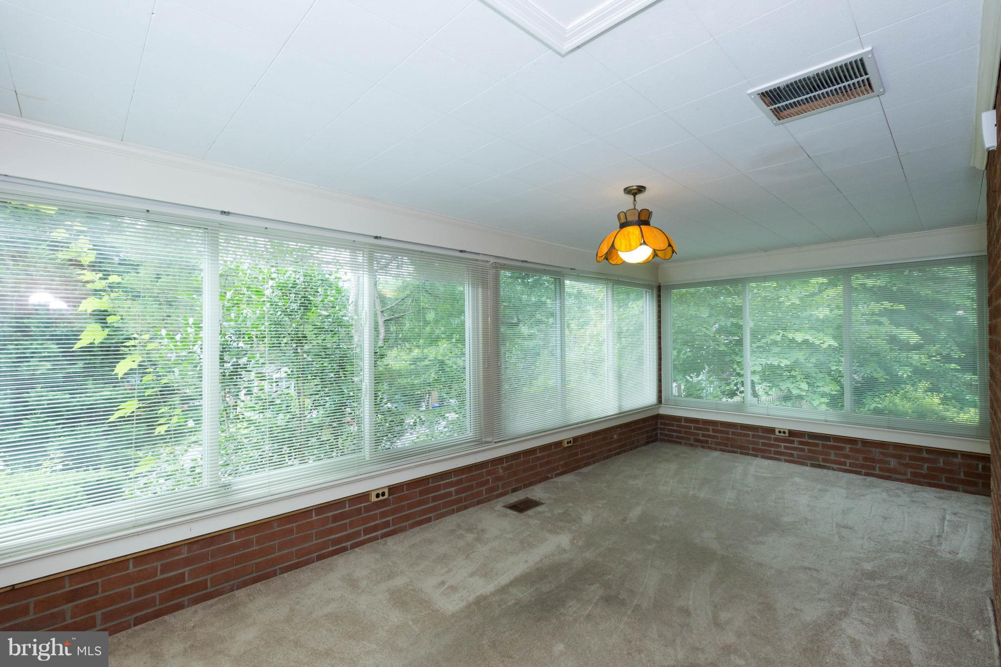 9600 Sutherland Road Silver Spring, MD 20901 - Photo 13 of 30 a view of an empty room with wooden floor and windows