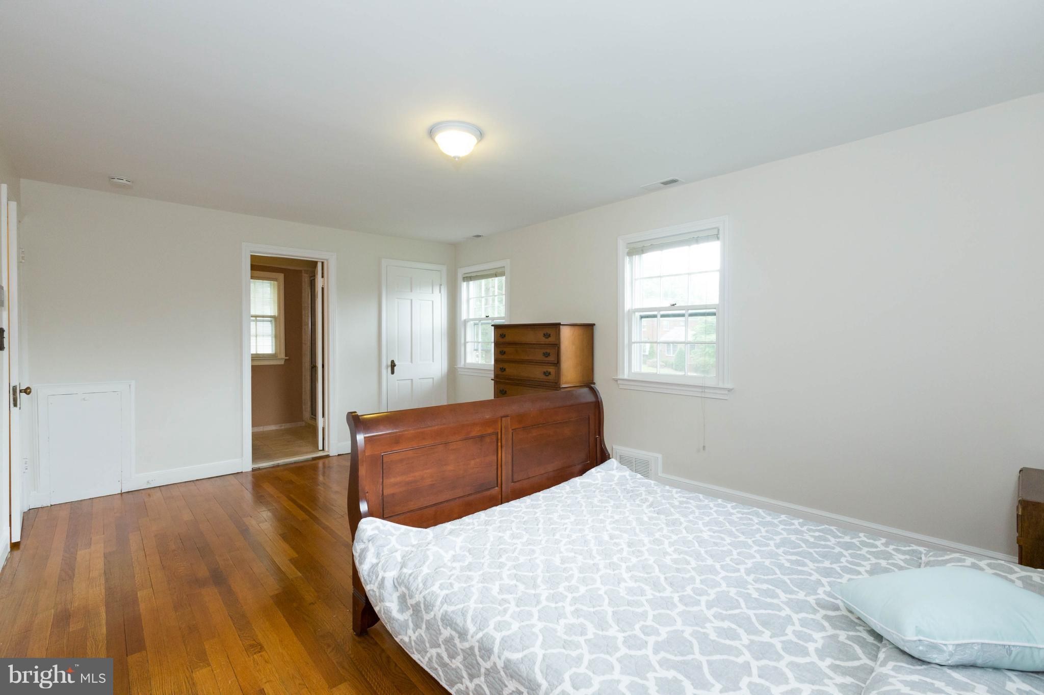 9600 Sutherland Road Silver Spring, MD 20901 - Photo 17 of 30 a bedroom with a bed and wooden floor