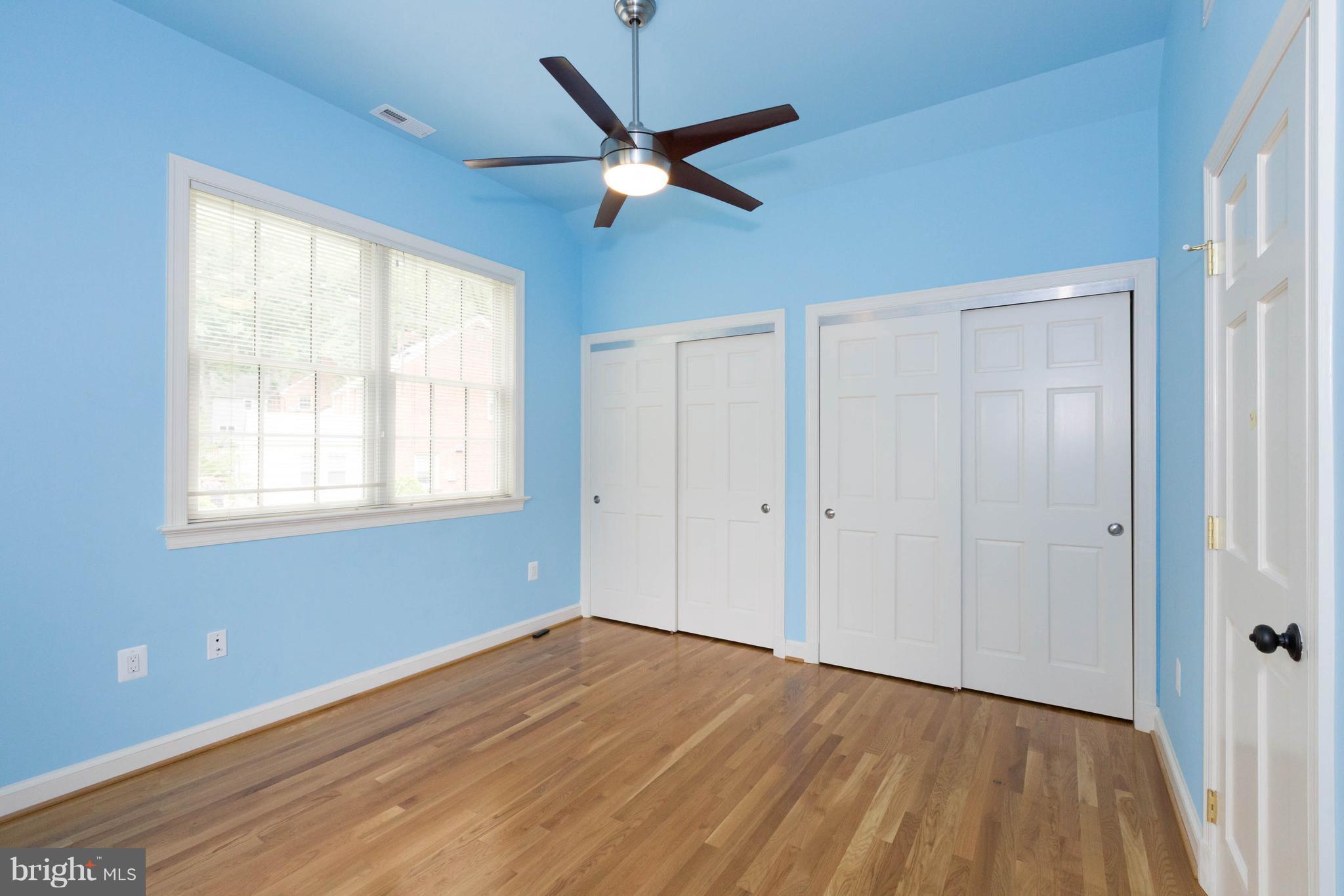 9600 Sutherland Road Silver Spring, MD 20901 - Photo 22 of 30 a view of an empty room with wooden floor and a ceiling fan