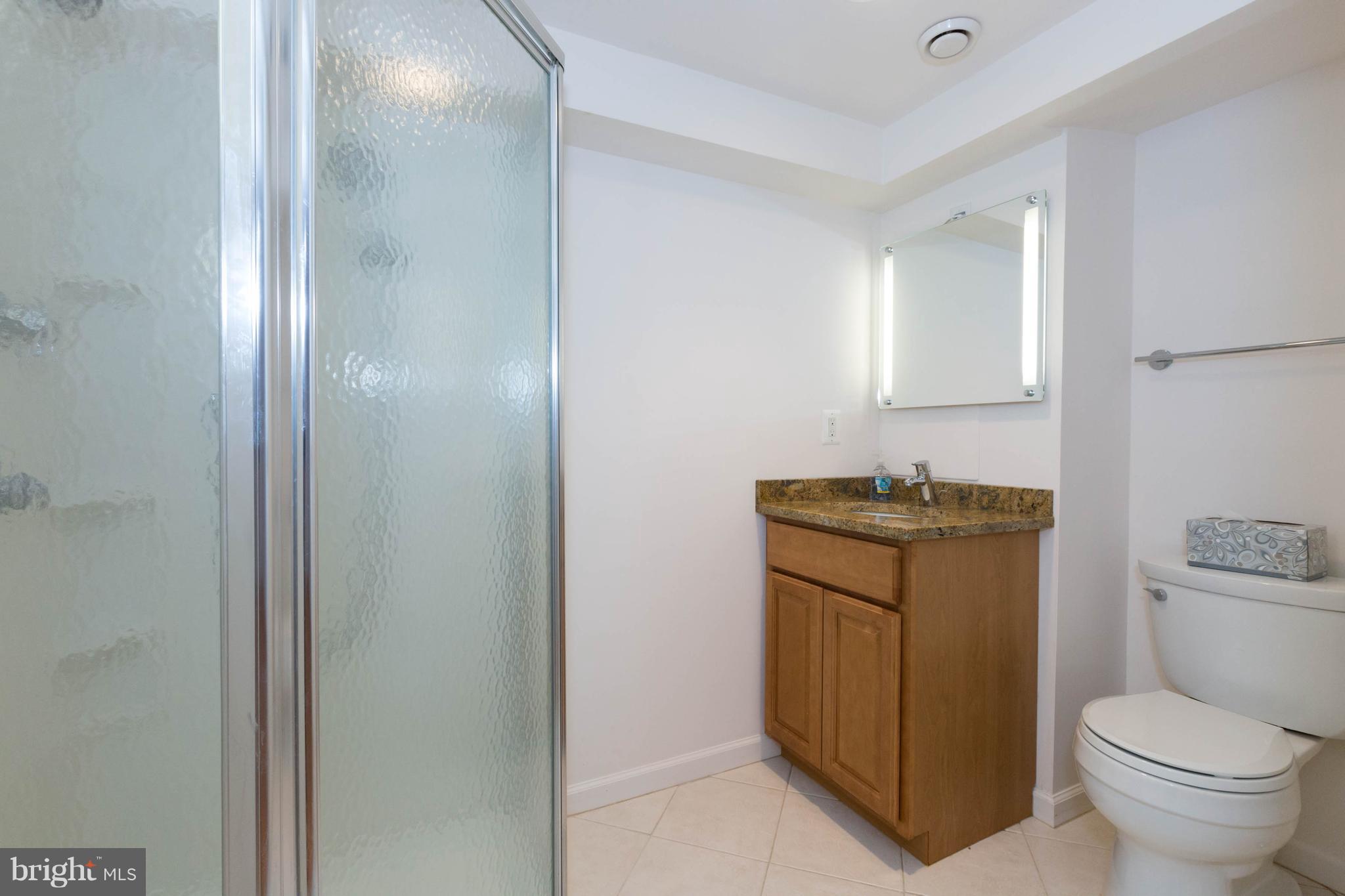 9600 Sutherland Road Silver Spring, MD 20901 - Photo 27 of 30 a bathroom with a toilet sink and mirror