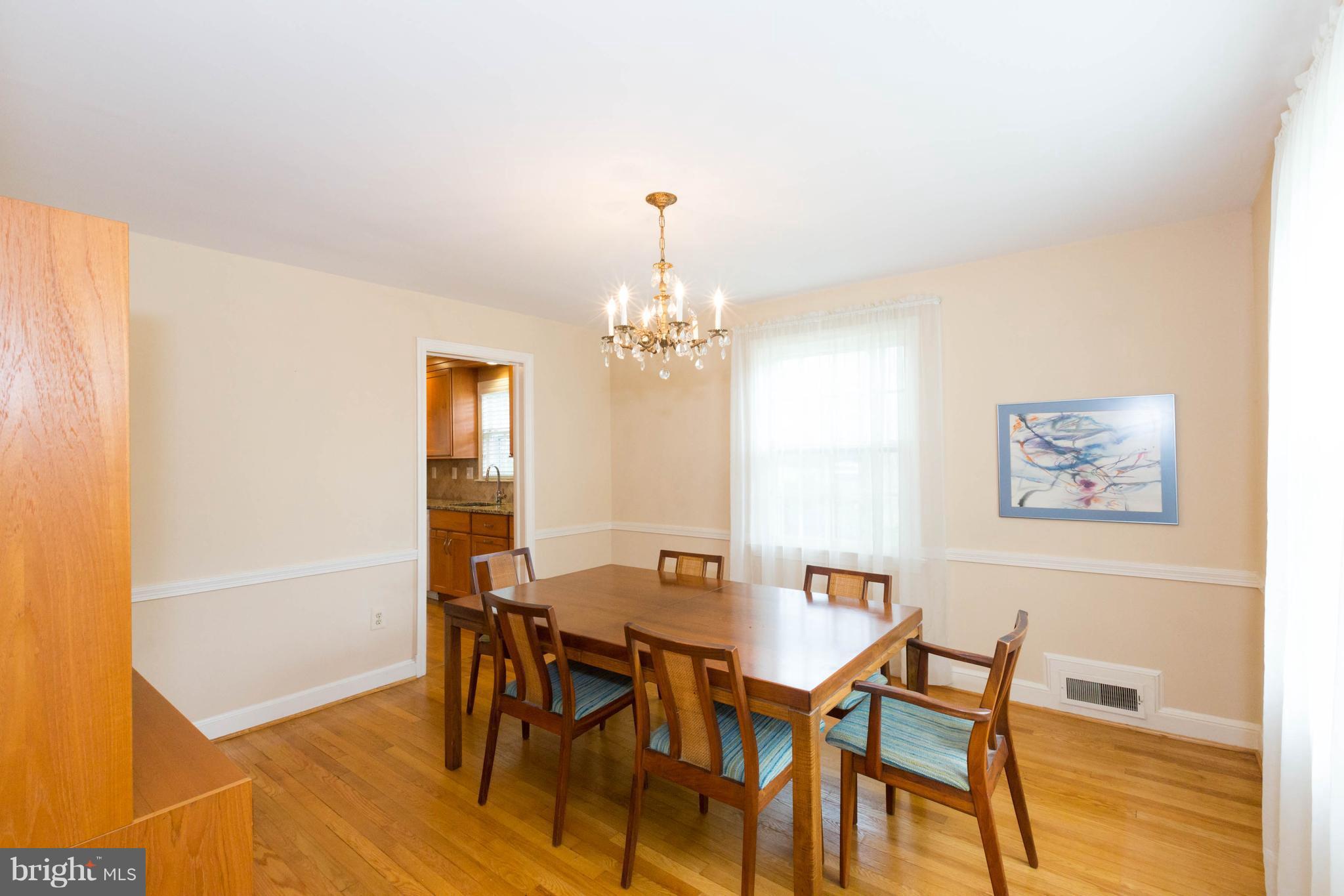 9600 Sutherland Road Silver Spring, MD 20901 - Photo 6 of 30 a view of a dining room with furniture and wooden floor