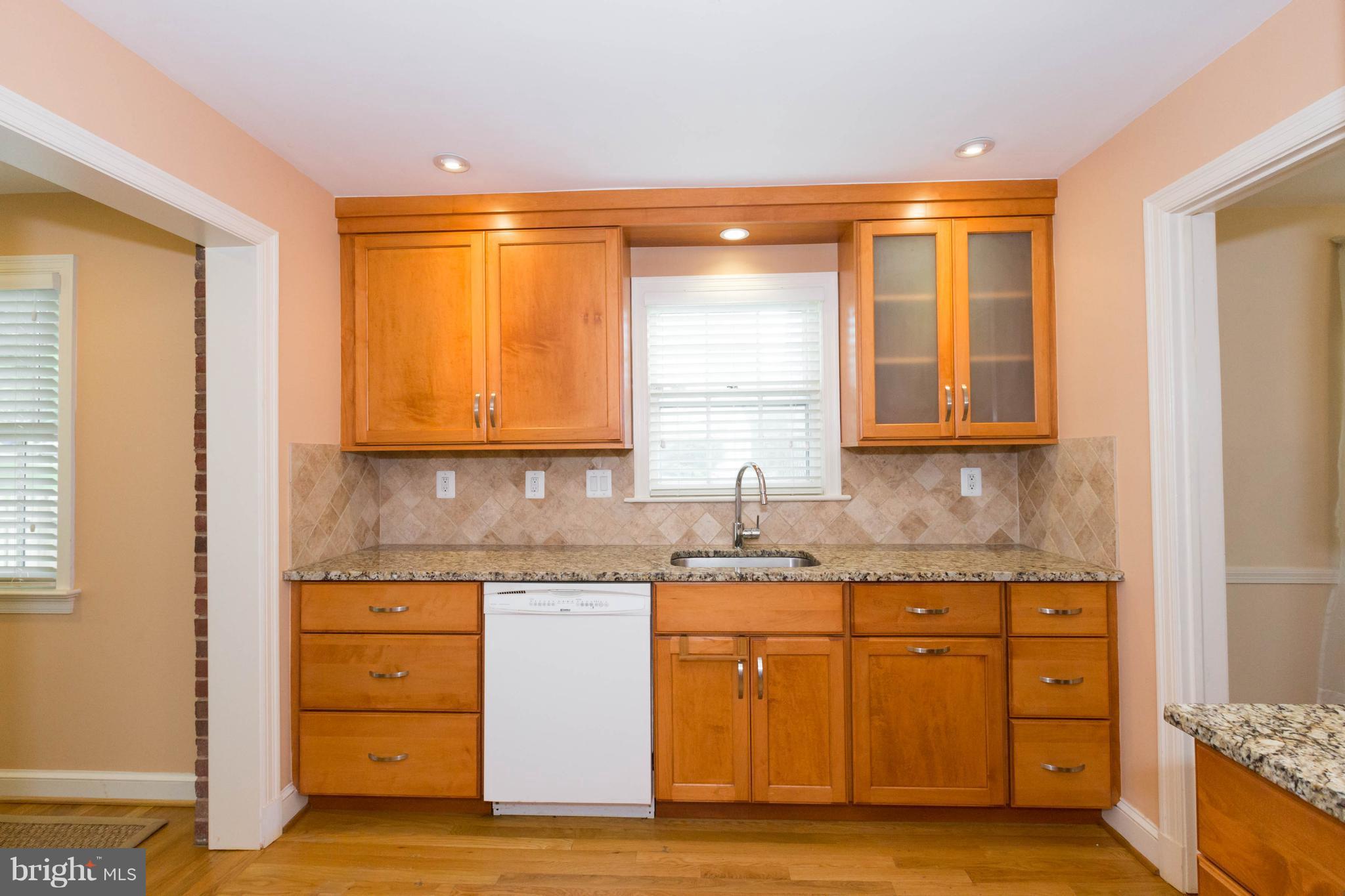 9600 Sutherland Road Silver Spring, MD 20901 - Photo 9 of 30 a kitchen with a sink a cabinets and window