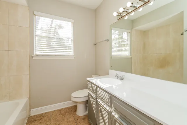 a bathroom with a sink a toilet and a bathtub