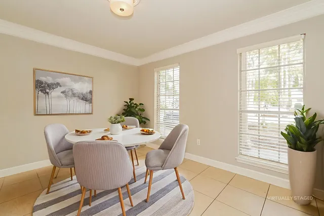 a view of a dining room with furniture and a potted plant