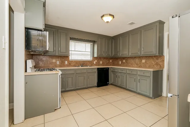a kitchen with a sink cabinets and window