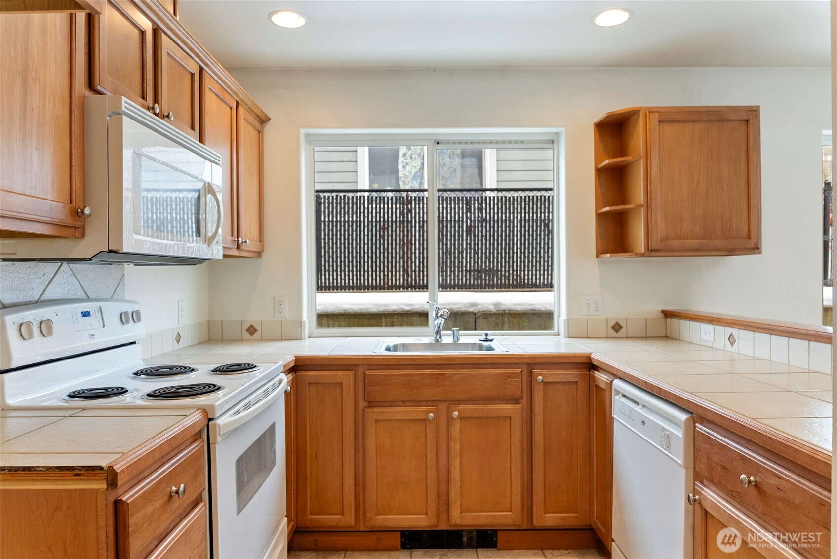 203 Washington Street Winthrop, WA 98862 - Photo 12 of 39 a kitchen with a sink stove and cabinets