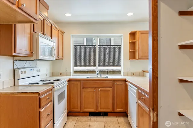 a kitchen that has a sink and a stove in it
