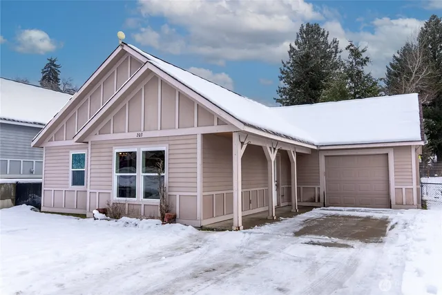 a view of a house with a yard and garage